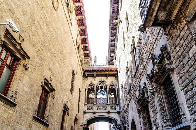 Carrer del Bisbe running between stone walls towards the Pont del Bisbe